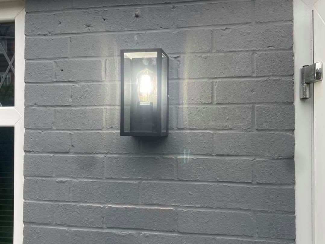 Box lantern wall light fitted beside a front door
