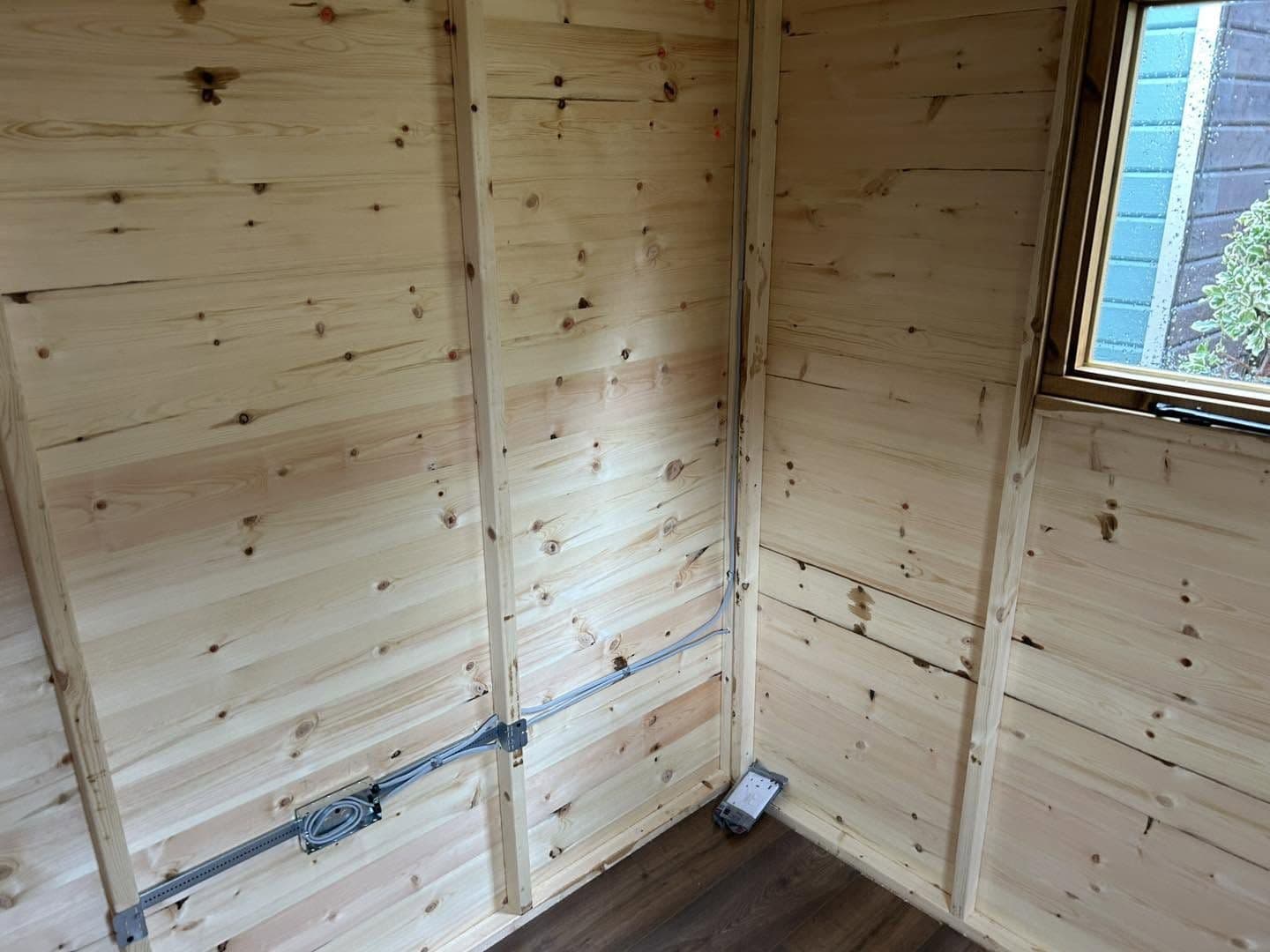 First-fix wiring run neatly in conduit inside a new garden room