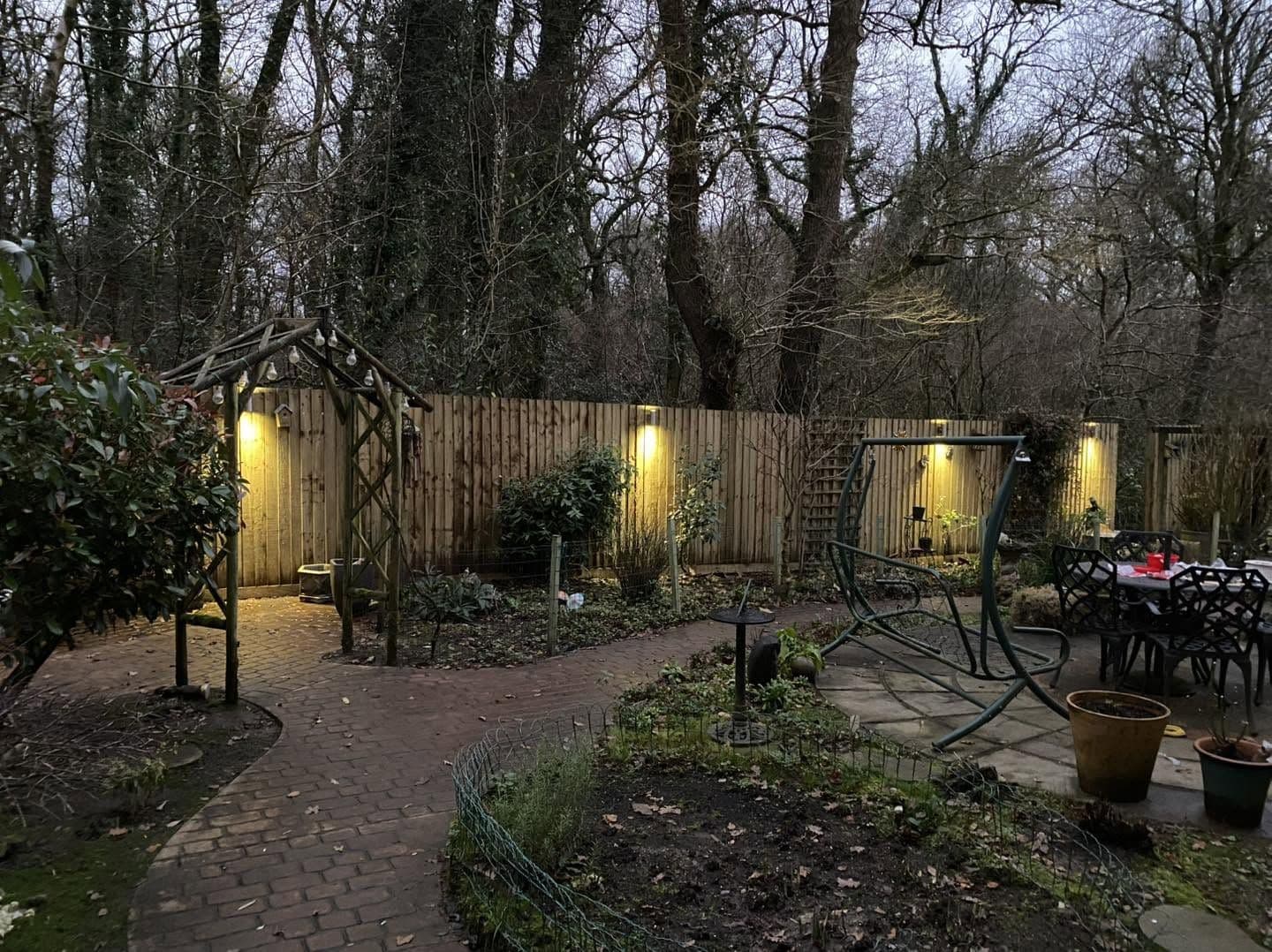 Garden lighting along a pergola and pathway at dusk