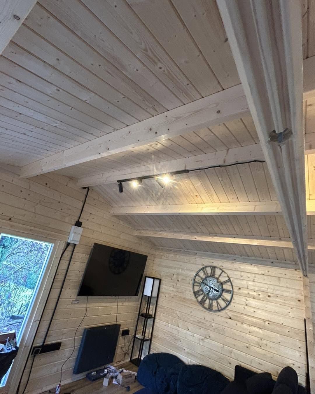 Garden room lighting with feature spots over a media wall